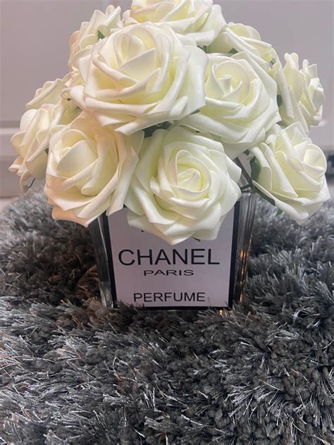 camilia chanel|Chanel vase with flowers.